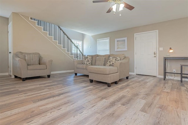 living room featuring ceiling fan and light hardwood / wood-style flooring