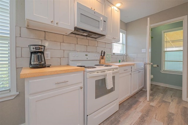 kitchen with white cabinets, white appliances, and sink