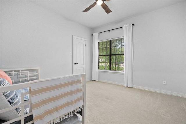 bedroom with carpet flooring, baseboards, and ceiling fan