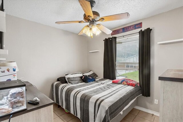 4622 Bluebelle Ln, Corpus Christi, TX 78416 - bedroom featuring light tile patterned floors, a textured ceiling, and ceiling fan