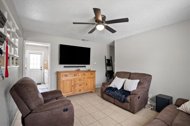 4622 Bluebelle Ln, Corpus Christi, TX 78416 - living area with a textured ceiling, a ceiling fan, light tile patterned flooring, and baseboards