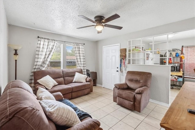 4622 Bluebelle Ln, Corpus Christi, TX 78416 - living room with a ceiling fan, a textured ceiling, light tile patterned flooring, and baseboards