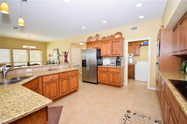 kitchen with stainless steel appliances, washer / clothes dryer, a sink, and visible vents