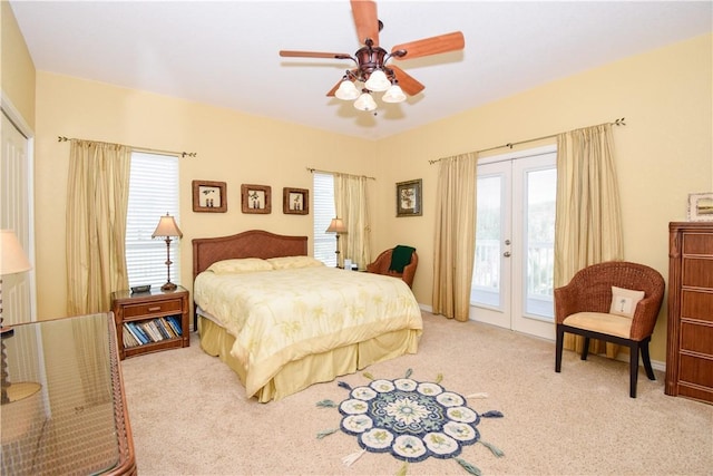 carpeted bedroom featuring access to exterior, a ceiling fan, and french doors