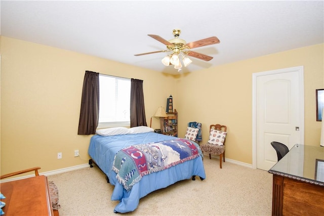 bedroom with light carpet, ceiling fan, and baseboards