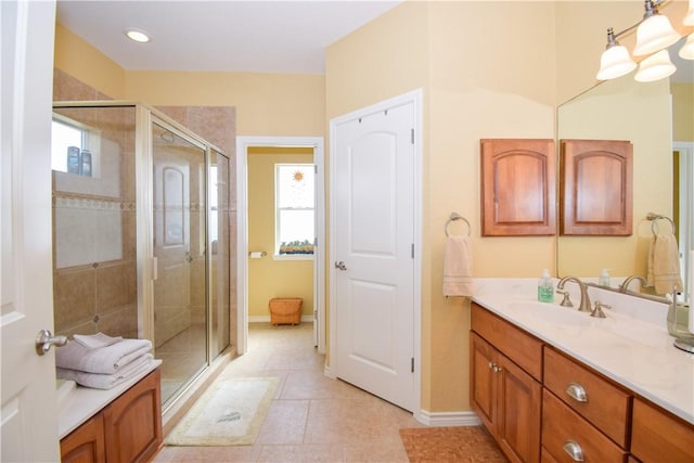 bathroom featuring a stall shower, baseboards, an inviting chandelier, tile patterned flooring, and vanity