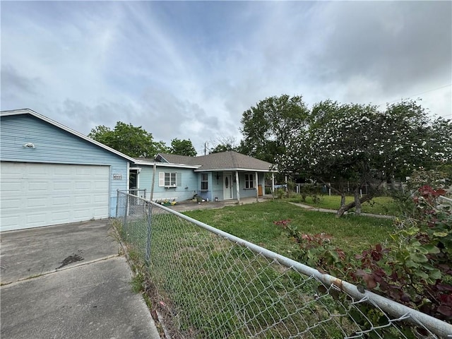 ranch-style home with a front yard, fence private yard, driveway, and an attached garage