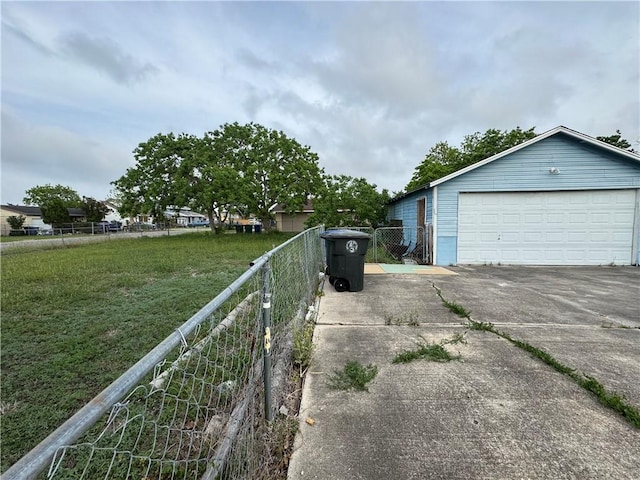 view of home's exterior with fence, an outdoor structure, a yard, and a detached garage