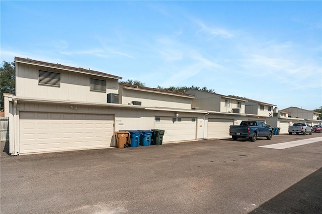 view of front facade with a residential view and central air condition unit