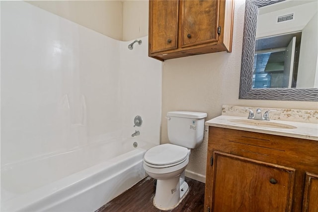 full bathroom with visible vents, toilet, wood finished floors, bathtub / shower combination, and vanity