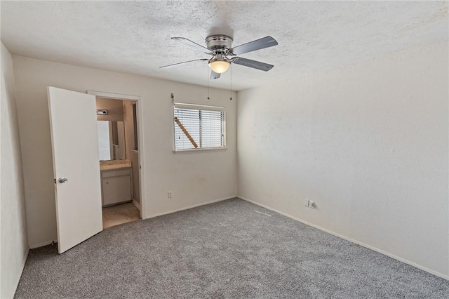 unfurnished bedroom featuring carpet, a ceiling fan, a textured ceiling, and ensuite bathroom