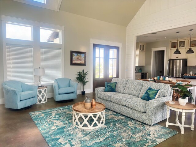 living room featuring high vaulted ceiling