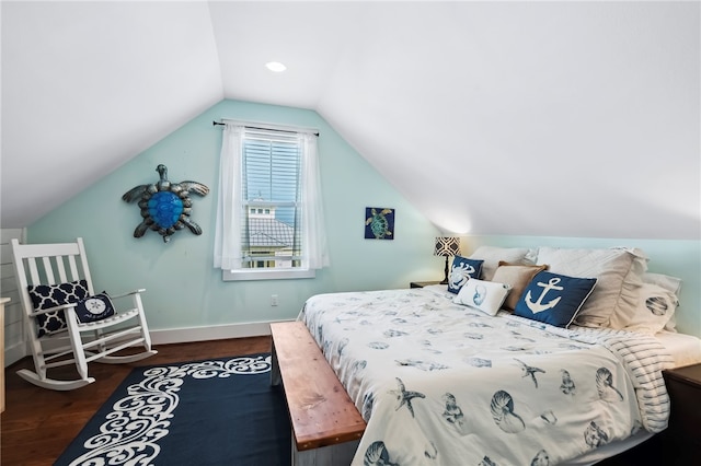 bedroom featuring dark wood-type flooring and vaulted ceiling