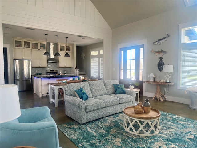 living room with high vaulted ceiling and a healthy amount of sunlight