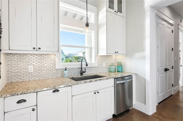 kitchen featuring white cabinetry, sink, backsplash, stainless steel dishwasher, and pendant lighting