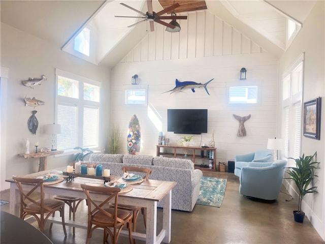 living room featuring high vaulted ceiling, concrete flooring, beamed ceiling, and ceiling fan