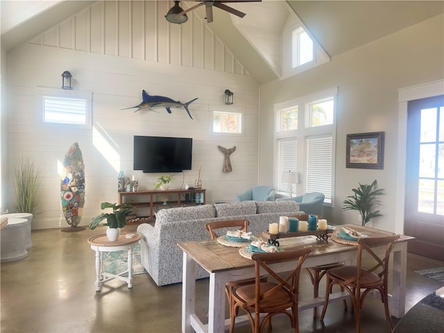 living room featuring high vaulted ceiling, concrete flooring, and ceiling fan