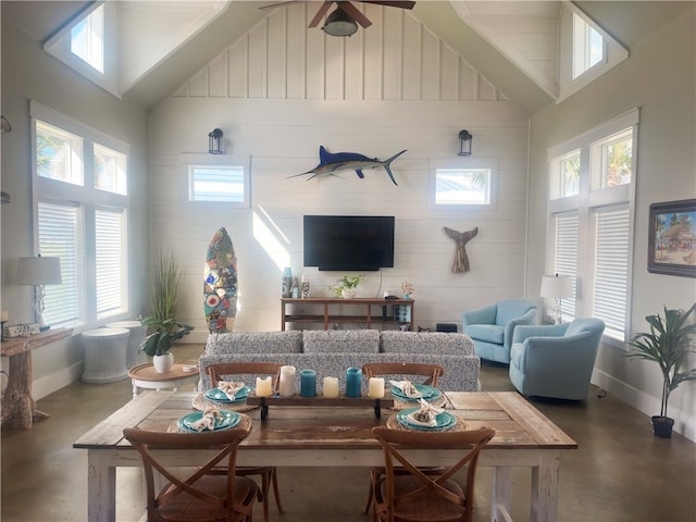 living room featuring concrete flooring, plenty of natural light, and high vaulted ceiling