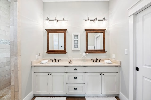 bathroom with vanity and tiled shower