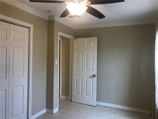 unfurnished bedroom featuring ornamental molding, ceiling fan, and a closet