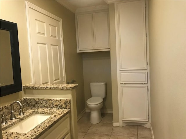 bathroom featuring vanity, tile patterned floors, and toilet