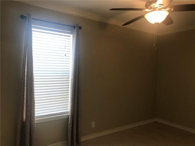 spare room with ornamental molding and ceiling fan