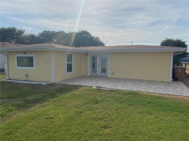 rear view of house featuring a yard, a patio, and french doors