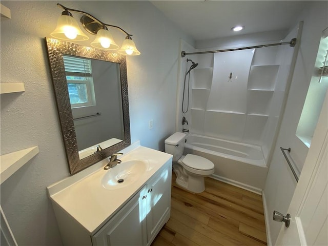 full bathroom with vanity, washtub / shower combination, toilet, and wood finished floors