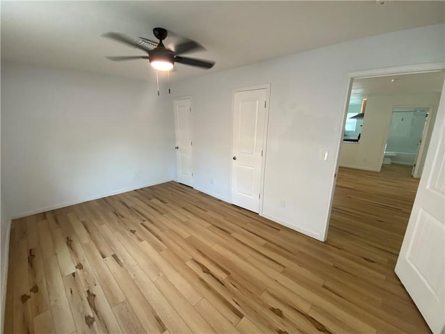 unfurnished bedroom featuring baseboards, light wood finished floors, and ceiling fan