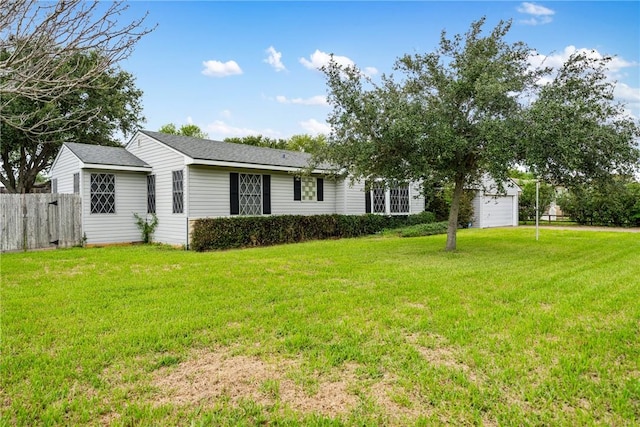 view of front of home with a front yard and a garage