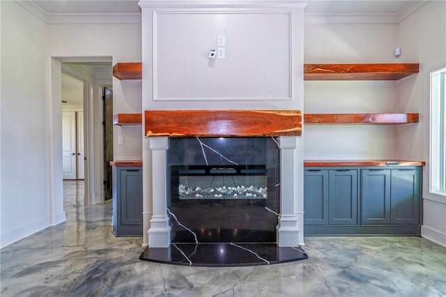 details featuring baseboards, ornamental molding, and a tile fireplace