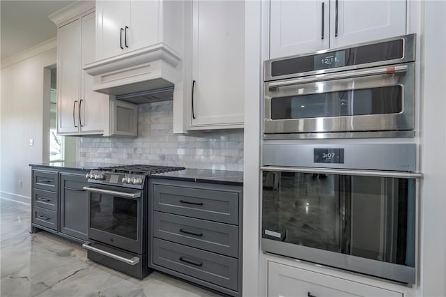 kitchen featuring appliances with stainless steel finishes, tasteful backsplash, custom exhaust hood, crown molding, and gray cabinets