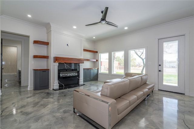 living room featuring ceiling fan and ornamental molding