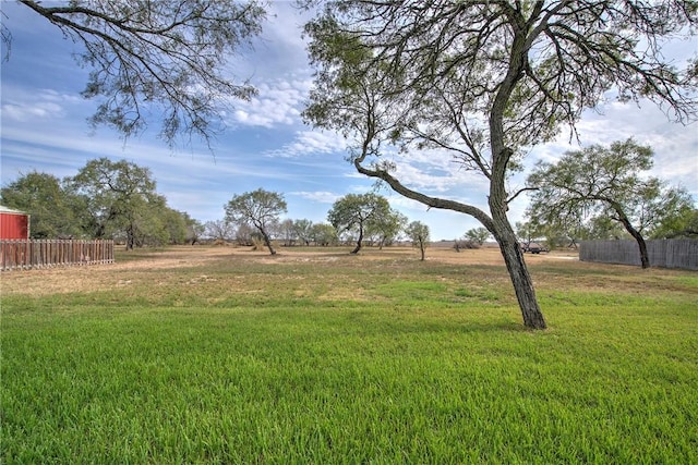 view of yard featuring a rural view and fence