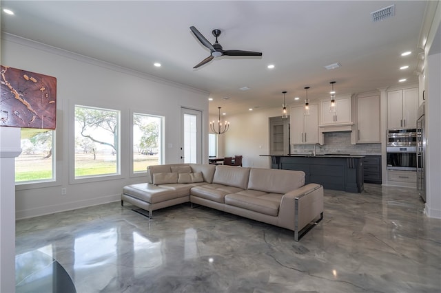 living room featuring crown molding, sink, and ceiling fan with notable chandelier