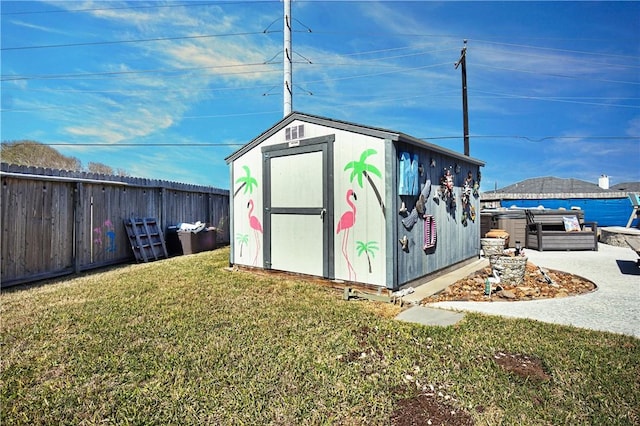 view of shed with a fenced backyard