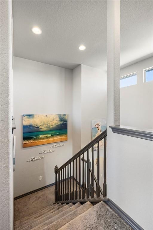 stairs with carpet flooring, recessed lighting, a textured ceiling, and baseboards