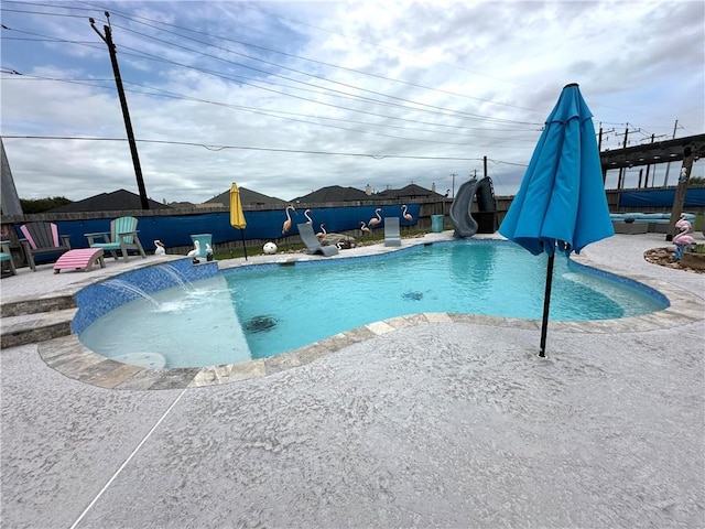 8218 Barlovento St, Corpus Christi, TX 78414 - view of pool with a water slide, a patio, and a fenced backyard