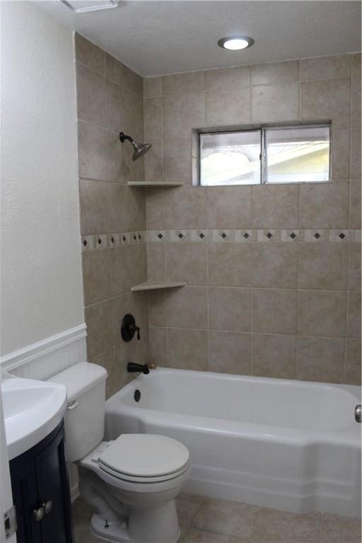 full bathroom with tiled shower / bath combo, vanity, tile patterned flooring, and toilet