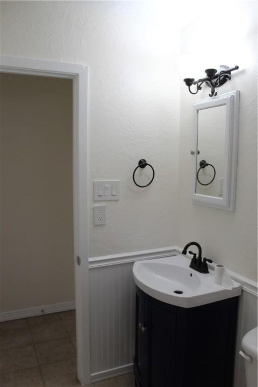 bathroom with vanity, tile patterned floors, and toilet