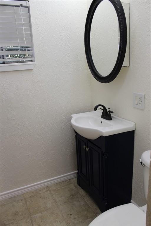 bathroom with tile patterned floors, vanity, and toilet