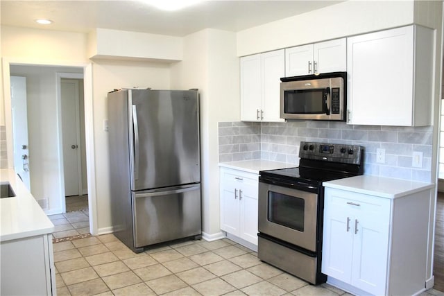 kitchen with white cabinetry, light tile patterned floors, tasteful backsplash, and stainless steel appliances