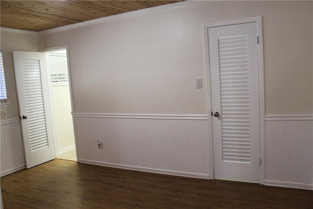 unfurnished bedroom with ornamental molding, dark hardwood / wood-style flooring, and wooden ceiling