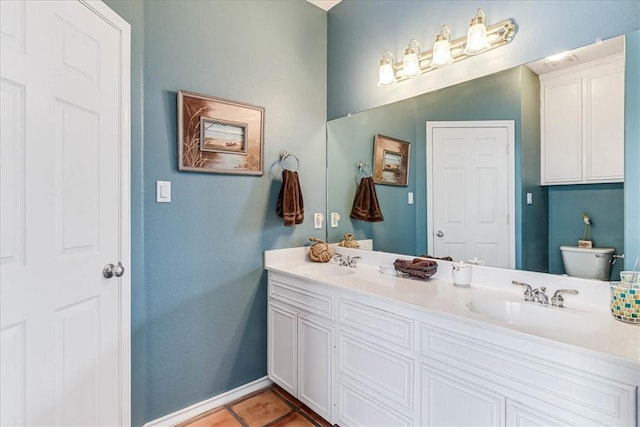 13530 Royal Fifth Ct, Corpus Christi, TX 78418 - bathroom with toilet, double vanity, baseboards, and tile patterned floors