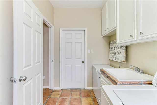 13530 Royal Fifth Ct, Corpus Christi, TX 78418 - washroom featuring cabinet space, baseboards, and washer and dryer