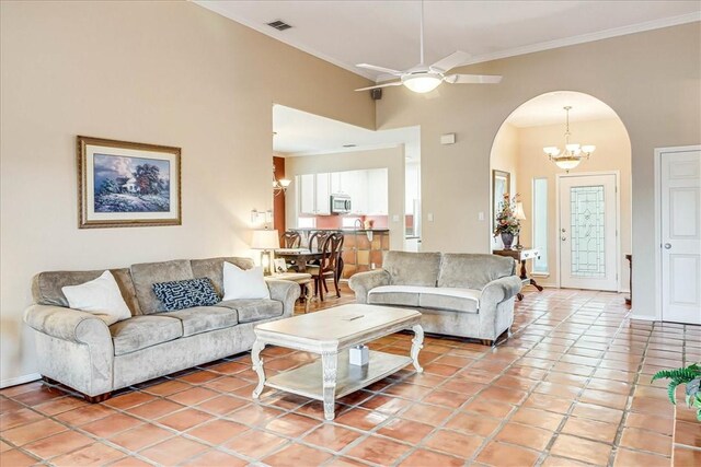 13530 Royal Fifth Ct, Corpus Christi, TX 78418 - living area featuring arched walkways, crown molding, built in shelves, a ceiling fan, and a fireplace
