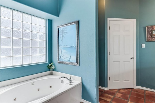 13530 Royal Fifth Ct, Corpus Christi, TX 78418 - full bath with baseboards, a jetted tub, tile patterned floors, and plenty of natural light