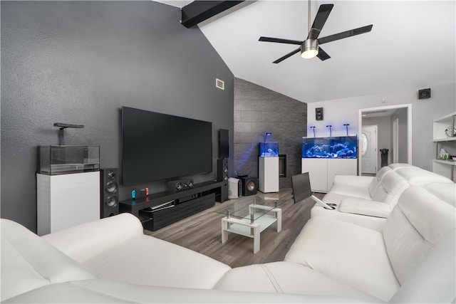 living room featuring ceiling fan, lofted ceiling with beams, and hardwood / wood-style flooring