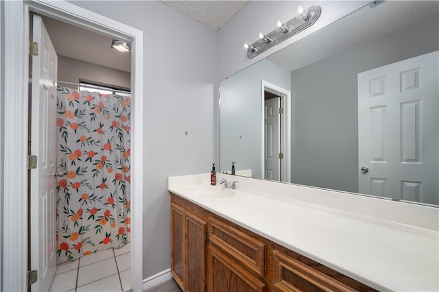 bathroom featuring vanity, a shower with curtain, tile patterned floors, and a textured ceiling