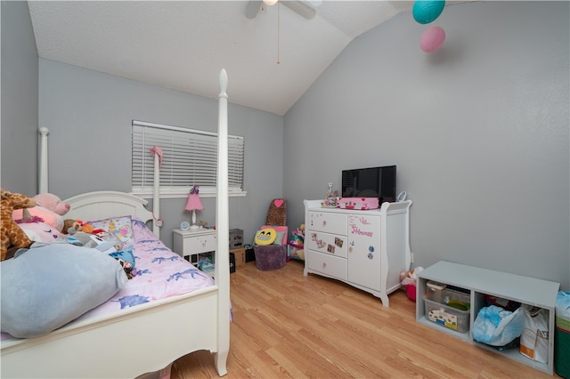 bedroom with lofted ceiling, ceiling fan, and light wood-type flooring